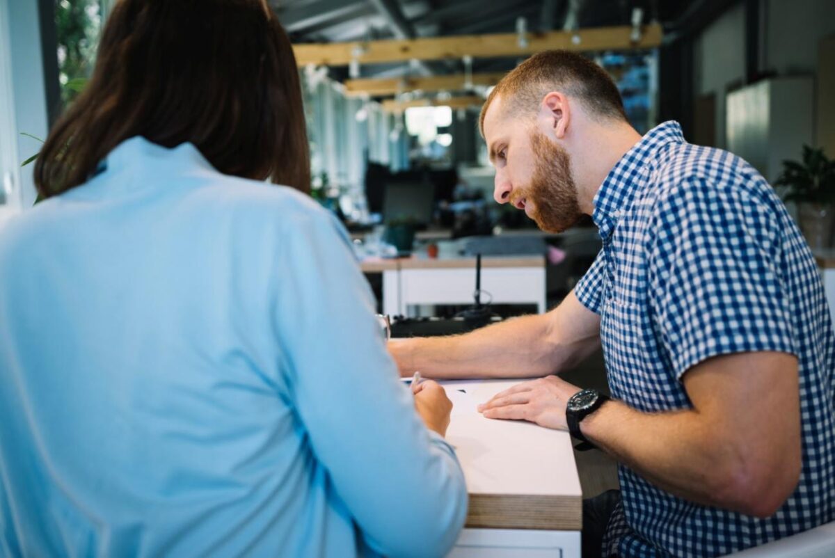 Duas pessoas conversando em ambiente empresarial